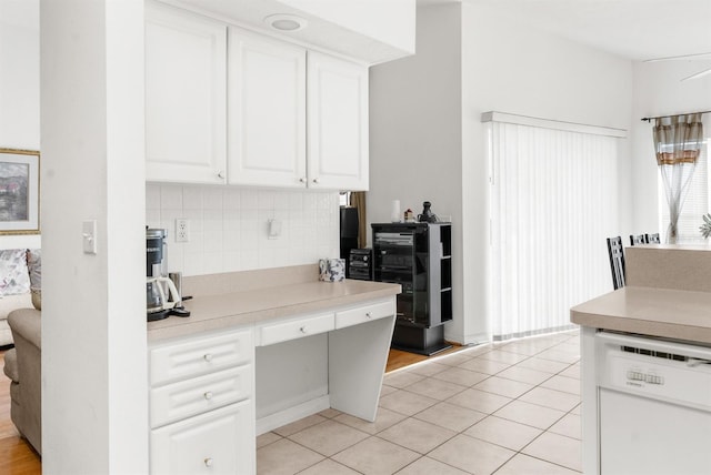 kitchen with dishwasher, decorative backsplash, white cabinetry, and light tile patterned flooring