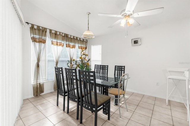 tiled dining space featuring lofted ceiling and ceiling fan