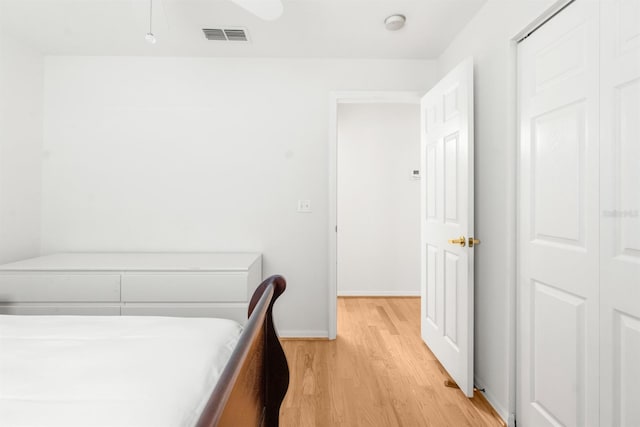 bedroom featuring light hardwood / wood-style floors and a closet