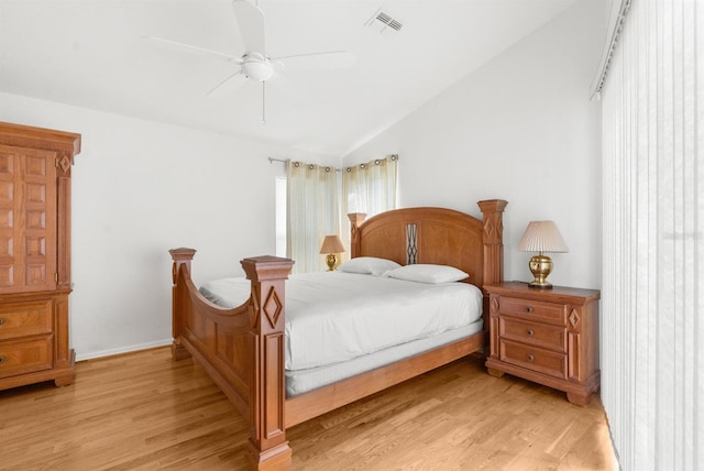 bedroom featuring light wood-type flooring, lofted ceiling, and ceiling fan