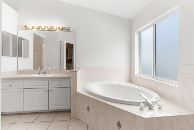 bathroom featuring vanity, tile patterned flooring, and shower with separate bathtub