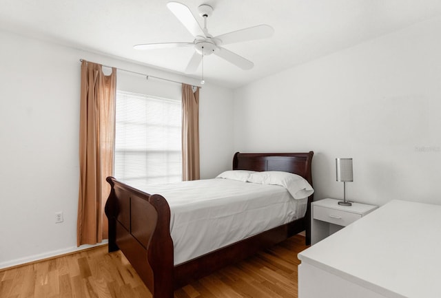 bedroom with light hardwood / wood-style floors and ceiling fan