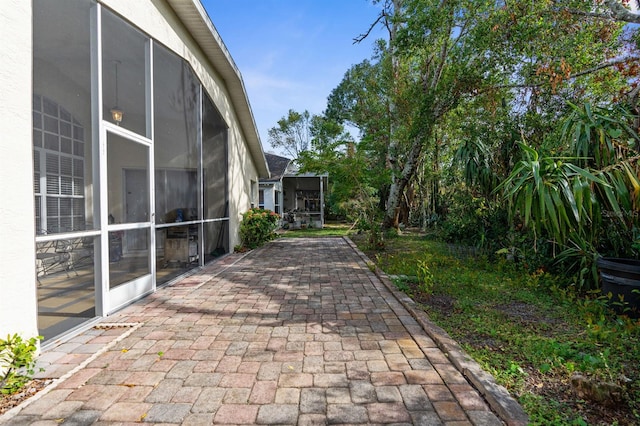 view of patio featuring a sunroom