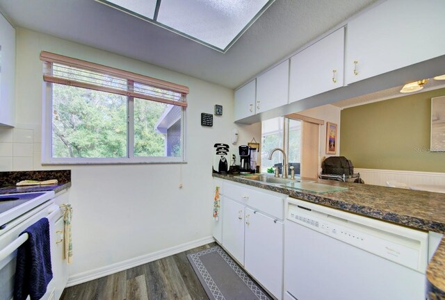 kitchen featuring white cabinets, white appliances, plenty of natural light, and sink