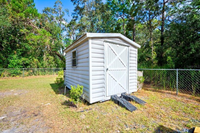 view of outbuilding featuring a lawn