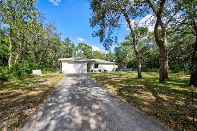 ranch-style home featuring a garage and a front yard