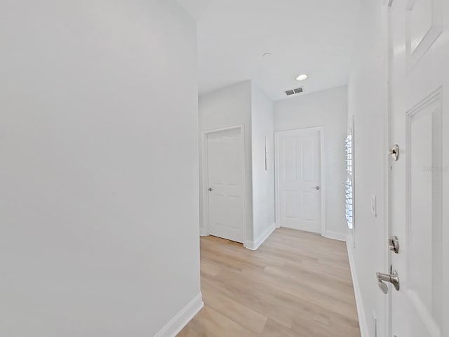 corridor featuring light hardwood / wood-style floors