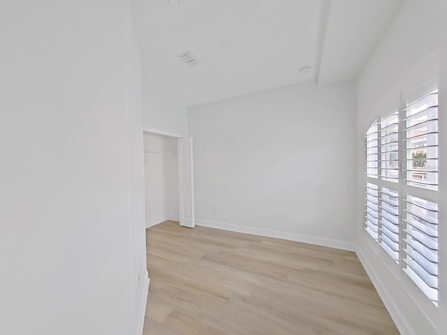 spare room with light hardwood / wood-style flooring