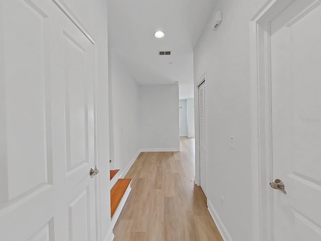 corridor with light hardwood / wood-style flooring