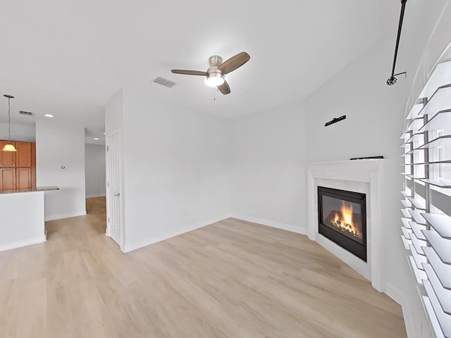 unfurnished living room featuring light hardwood / wood-style floors and ceiling fan