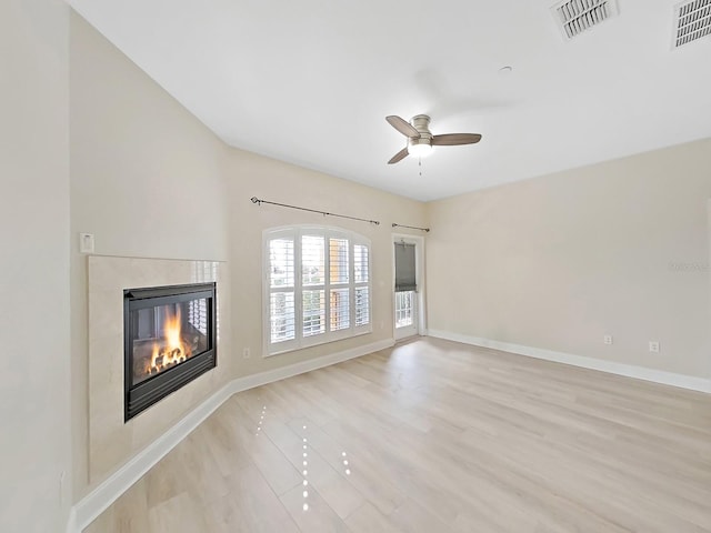 unfurnished living room featuring ceiling fan and light hardwood / wood-style flooring