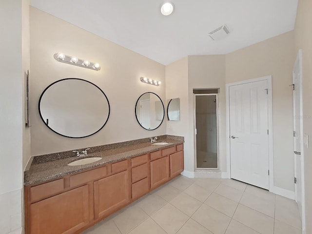 bathroom featuring vanity, tile patterned floors, and an enclosed shower