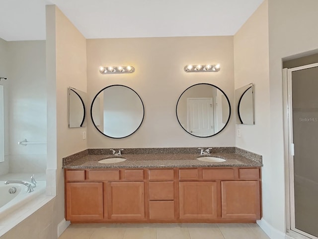 bathroom featuring tile patterned flooring, vanity, and separate shower and tub