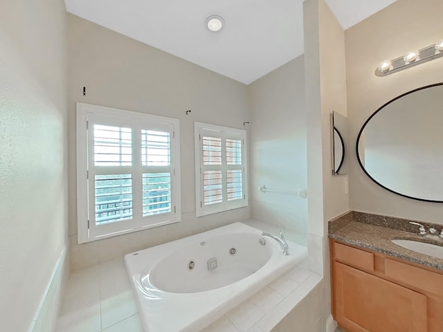 bathroom with tile patterned flooring, vanity, and a relaxing tiled tub