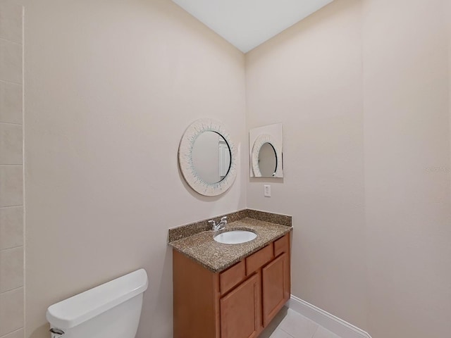 bathroom featuring tile patterned flooring, vanity, and toilet