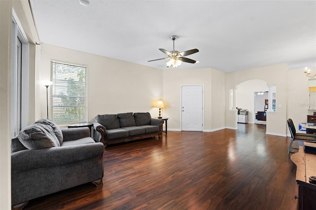 living room with dark wood-type flooring and ceiling fan