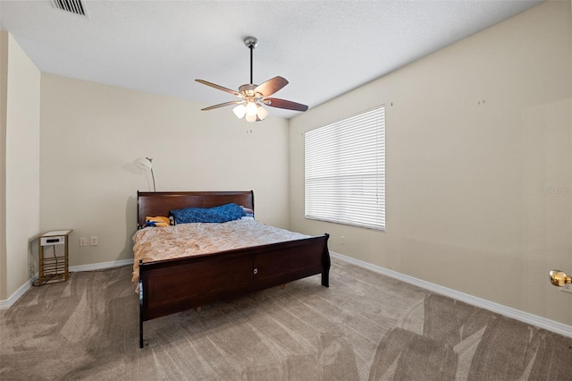 bedroom featuring light carpet, ceiling fan, visible vents, and baseboards