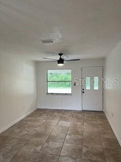 tiled foyer with ceiling fan