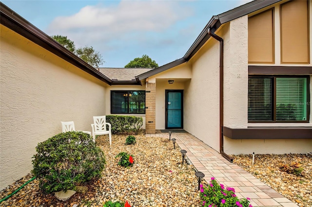 7499 Heather Walk, Weeki Wachee, FL 34613 - view of exterior entry featuring stucco siding