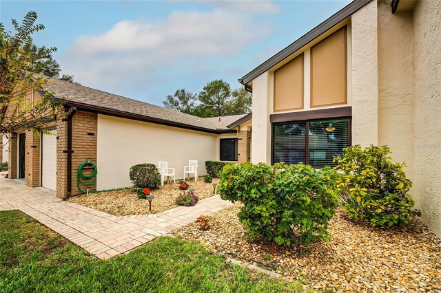 7499 Heather Walk, Weeki Wachee, FL 34613 - view of home's exterior with brick siding, stucco siding, and an attached garage