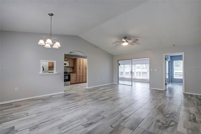 unfurnished living room with ceiling fan with notable chandelier, lofted ceiling, and light wood-type flooring