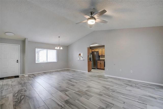 7499 Heather Walk, Weeki Wachee, FL 34613 - unfurnished living room with ceiling fan, a chandelier, lofted ceiling, baseboards, and arched walkways