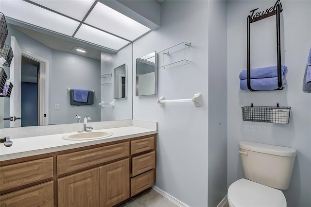 7499 Heather Walk, Weeki Wachee, FL 34613 - bathroom with toilet, vanity, and baseboards