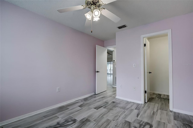 unfurnished bedroom featuring a textured ceiling, ceiling fan, and a closet