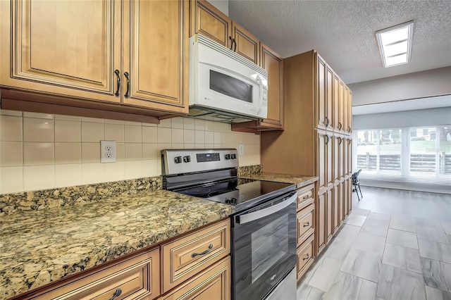 7499 Heather Walk, Weeki Wachee, FL 34613 - kitchen featuring white microwave, stainless steel electric range oven, decorative backsplash, brown cabinets, and light stone counters