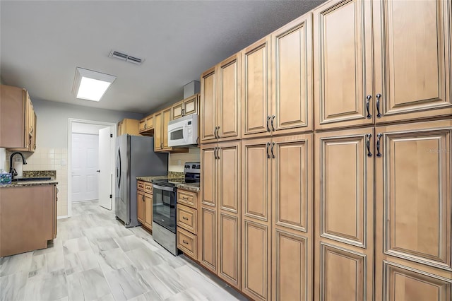 7499 Heather Walk, Weeki Wachee, FL 34613 - kitchen featuring appliances with stainless steel finishes, a sink, and dark stone counters