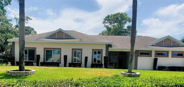 7499 Heather Walk, Weeki Wachee, FL 34613 - view of front of property with a front yard, stucco siding, and a shingled roof