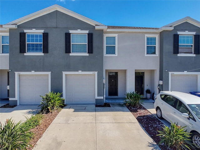 multi unit property featuring a garage