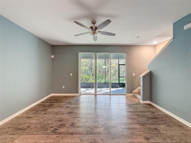 unfurnished room with a textured ceiling, hardwood / wood-style flooring, and ceiling fan