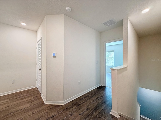 hall with dark wood-type flooring