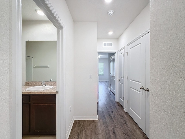 hall featuring sink and dark hardwood / wood-style floors