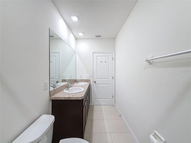 bathroom with tile patterned floors, vanity, and toilet