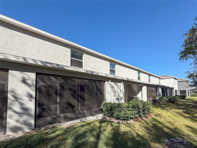 view of side of home featuring a yard