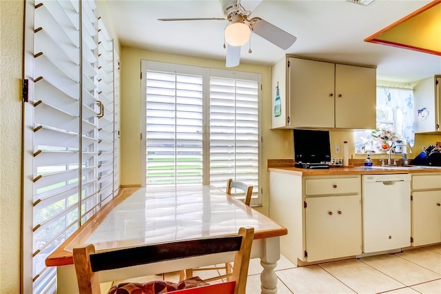 kitchen with cream cabinets, dishwasher, light tile patterned floors, sink, and ceiling fan