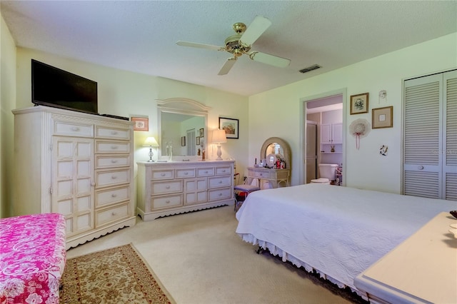 carpeted bedroom with a closet, a textured ceiling, and ceiling fan