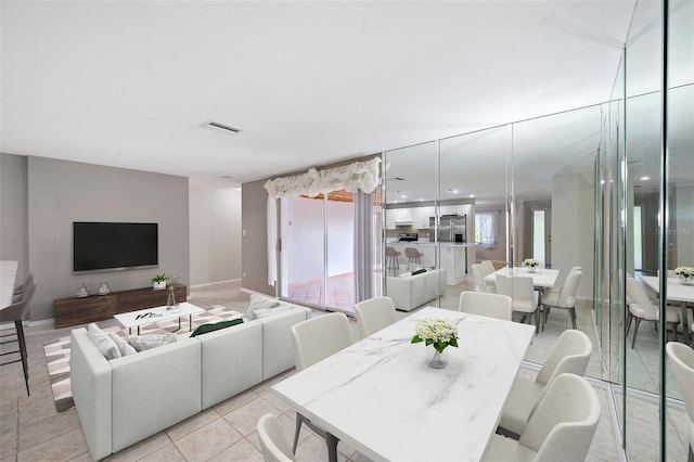 dining area featuring a healthy amount of sunlight and light tile patterned flooring