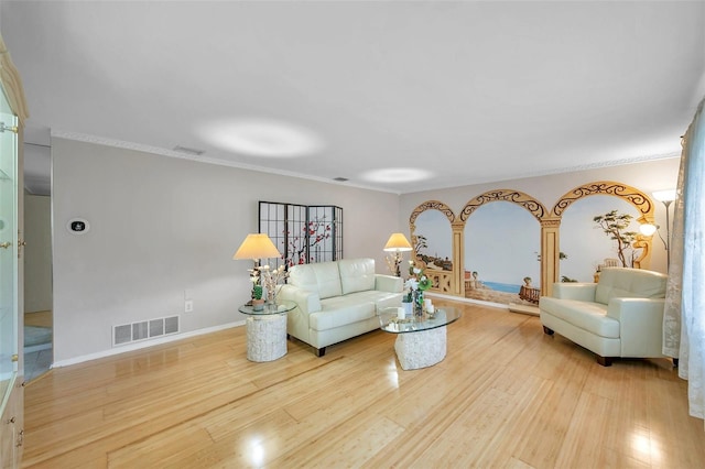 living room with light hardwood / wood-style floors and crown molding