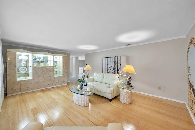 living room with hardwood / wood-style flooring and crown molding