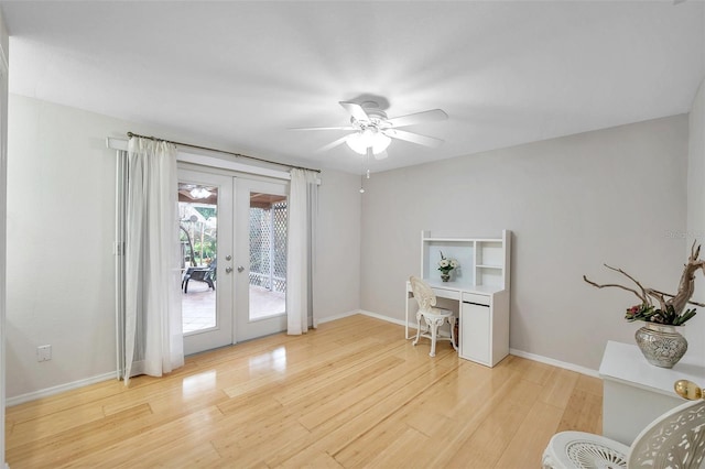 home office featuring french doors, ceiling fan, and light wood-type flooring