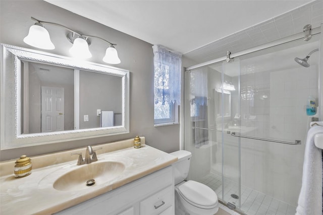 bathroom with vanity, toilet, and an enclosed shower