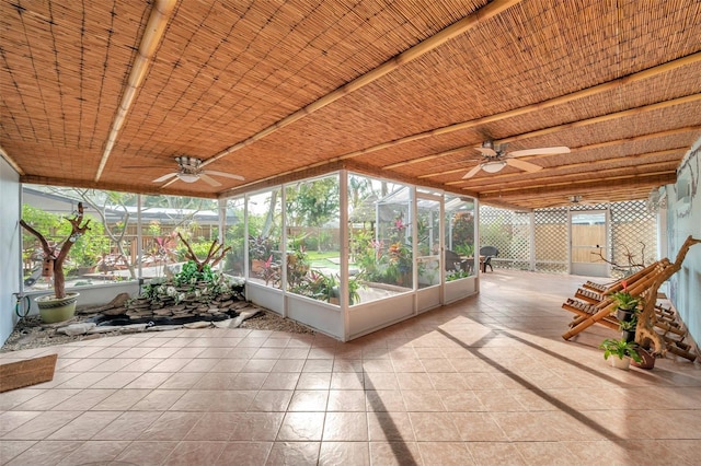 unfurnished sunroom featuring ceiling fan