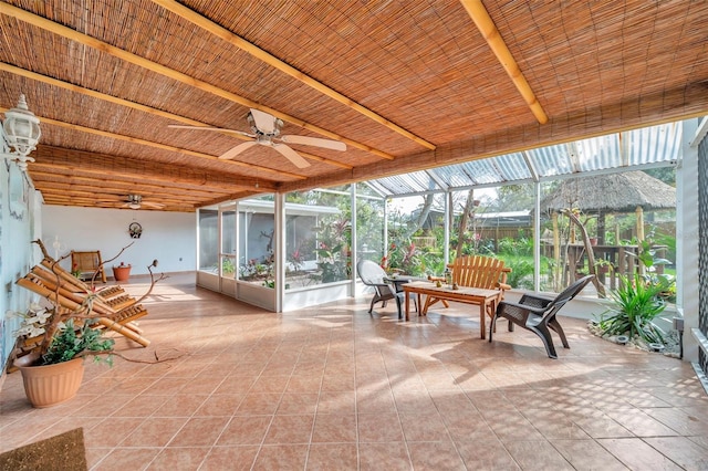 sunroom featuring ceiling fan and plenty of natural light