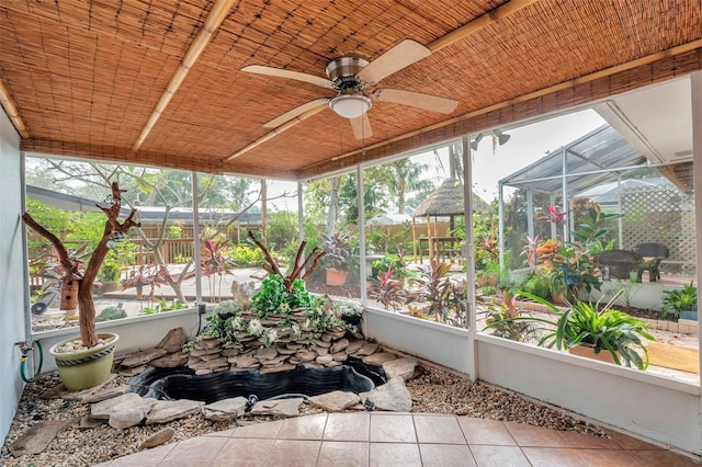 sunroom with a wealth of natural light and ceiling fan