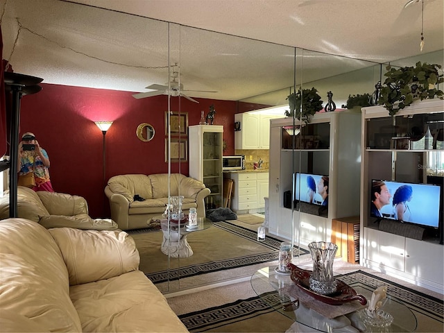 living room with a textured ceiling and ceiling fan