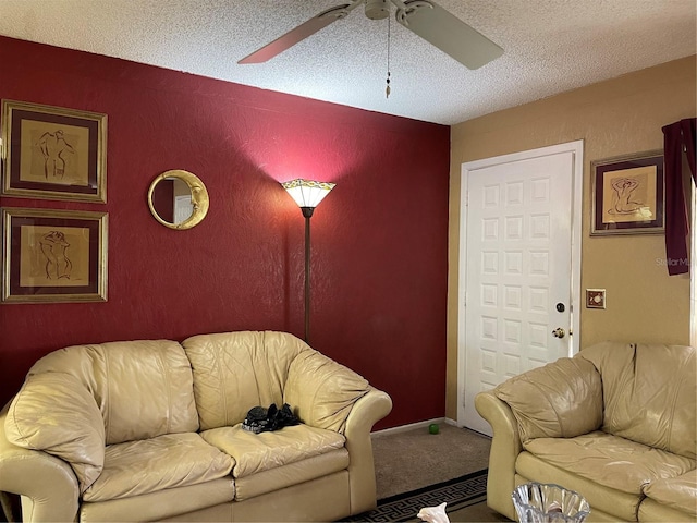 carpeted living room featuring a textured ceiling and ceiling fan