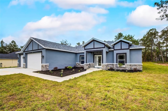 view of front of property featuring a garage, a front yard, and french doors